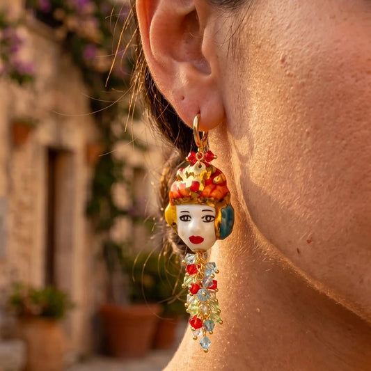 Woman wearing handmade Sicilian Moor’s Head earring in hand-painted Caltagirone ceramic with Swarovski crystals