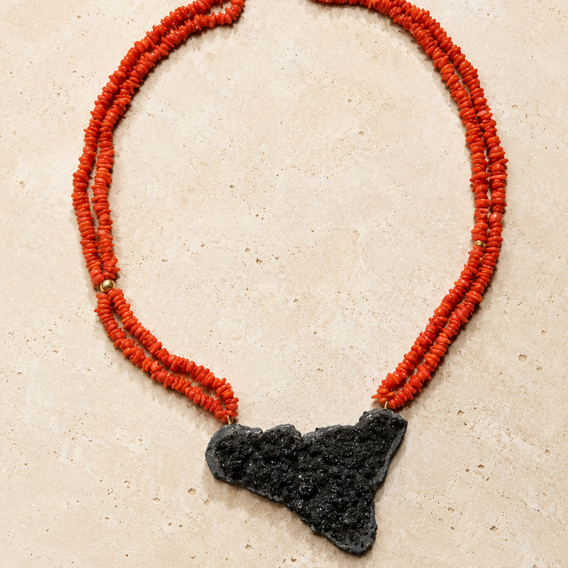 Full view of handmade Sicilian red coral necklace with Sicily-shaped Mount Etna lava stone pendant