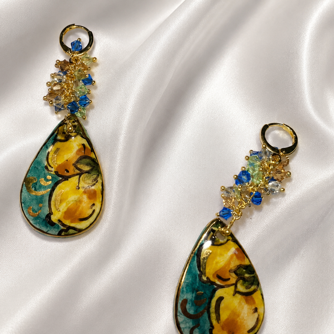 Pair of handmade Sicilian drop earrings with hand-painted Caltagirone ceramic lemon motifs, gold lustre and blue Swarovski crystals