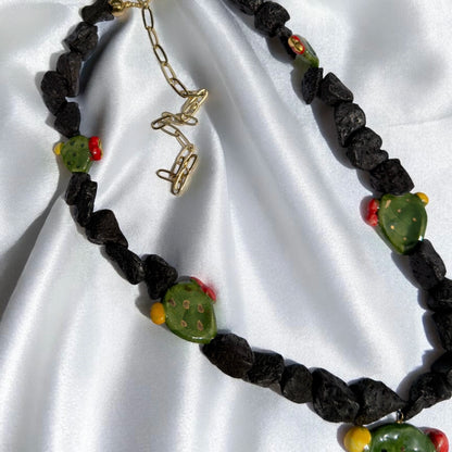 Handmade Sicilian necklace with Mount Etna lava stone, hand-painted Caltagirone ceramic prickly pear details and gold-tone extension chain
