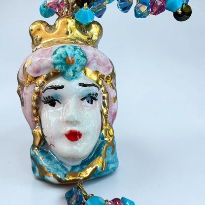 Close-up of hand-painted Caltagirone ceramic Moor’s Head pendant on a handmade Sicilian bracelet
