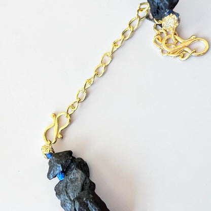 Gold-tone clasp and extension chain detail on handmade Sicilian Etna lava stone necklace