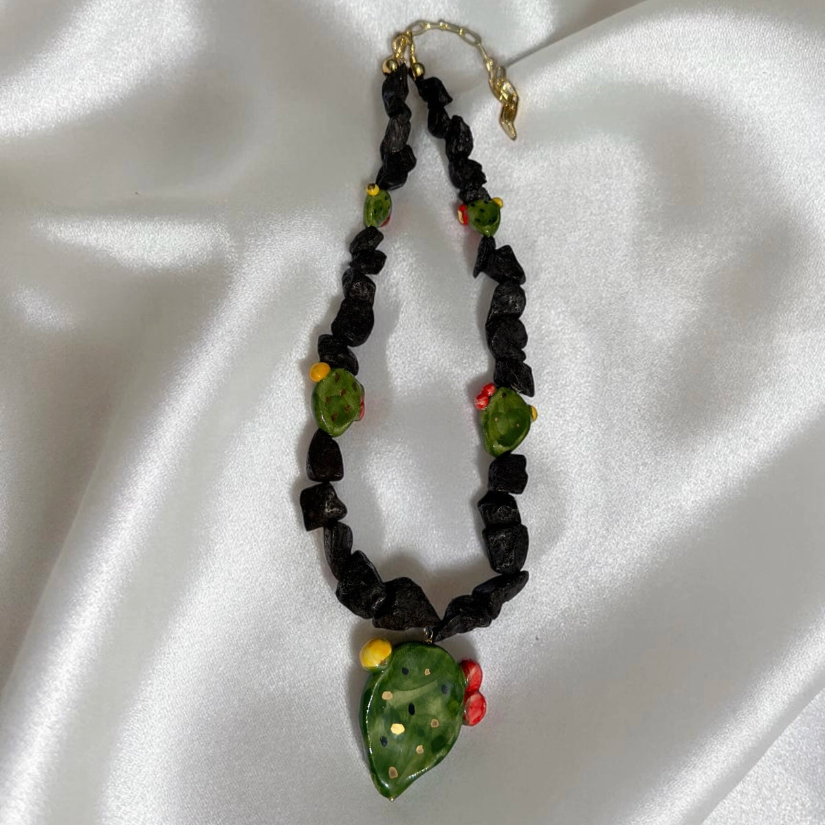 Full view of handmade Sicilian necklace with Mount Etna lava stone and hand-painted Caltagirone ceramic prickly pear pendant