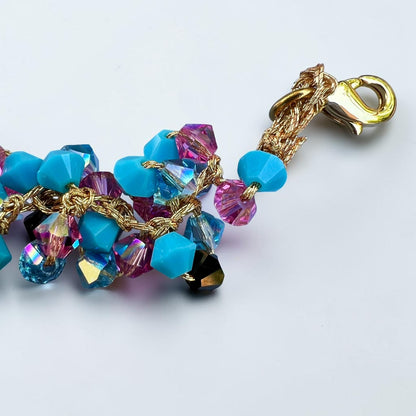 Close-up of gold-tone clasp and turquoise Swarovski crystal details on a handmade Sicilian bracelet