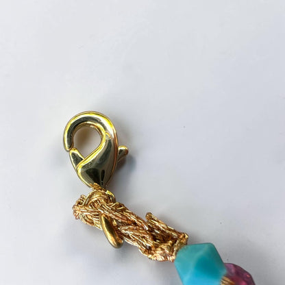 Close-up of gold-tone lobster clasp and crochet braid on a handmade Sicilian crystal bracelet