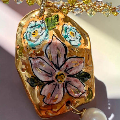 Hand-painted Caltagirone ceramic floral pendant with pearl on handmade Sicilian necklace