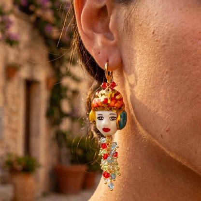 Woman wearing handmade Sicilian Moor’s Head earring in hand-painted Caltagirone ceramic with Swarovski crystals
