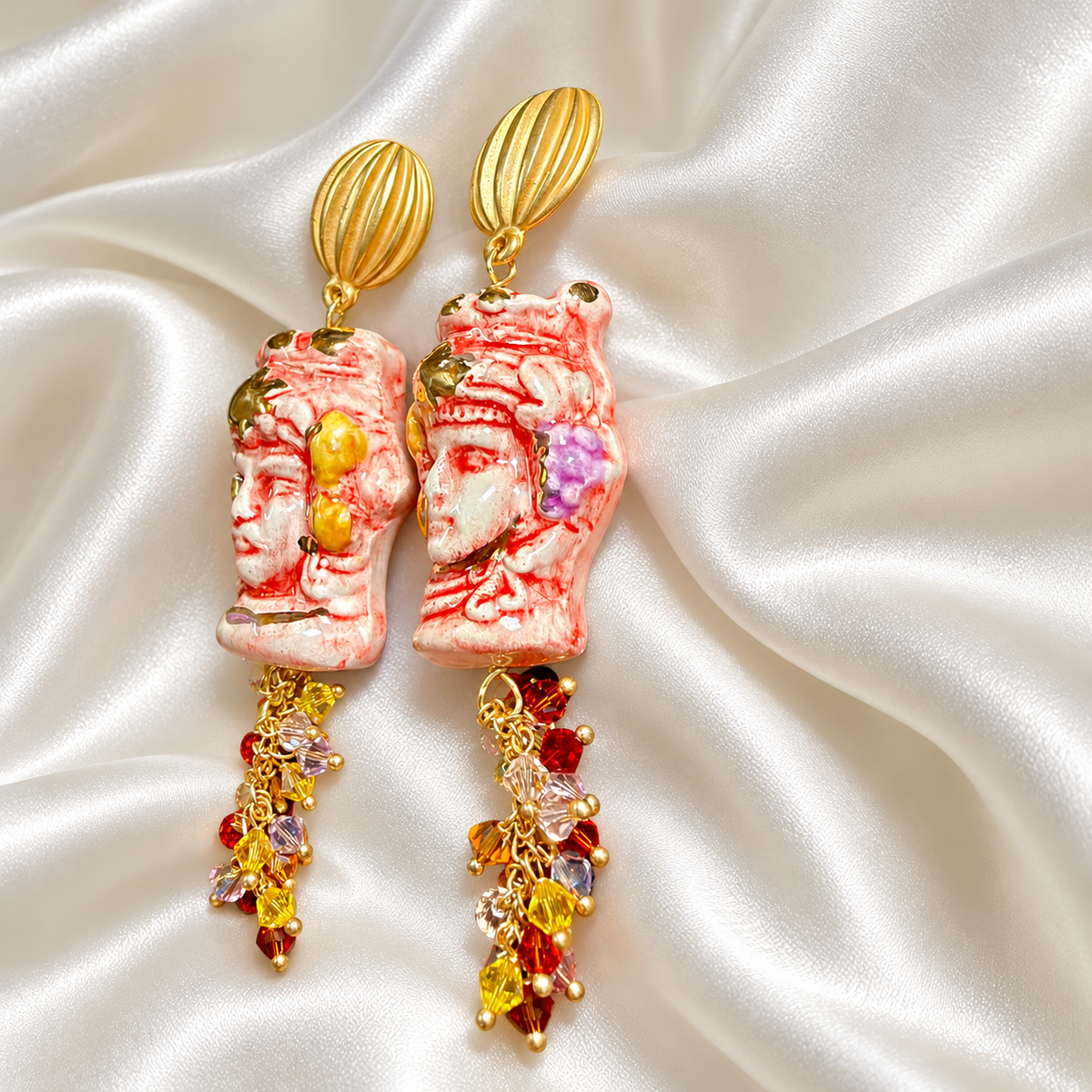 Side view of hand-painted Caltagirone ceramic Moor’s Head earrings in red and white with 10% gold lustre, Swarovski crystals and gold-tone details.